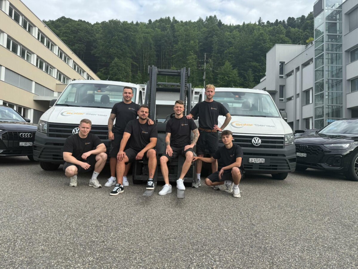 Das SolarSense-Team vor zwei Firmenfahrzeugen und einem Stapler am Standort Grossmatte Ost in Luzern.